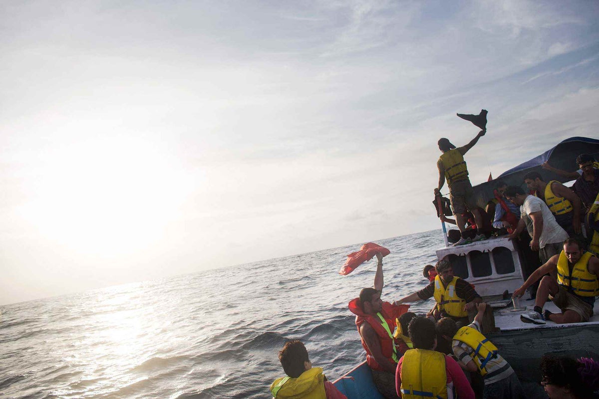Asylum seekers signal for help while making their way across the Indian Ocean towards Australia in 2013
