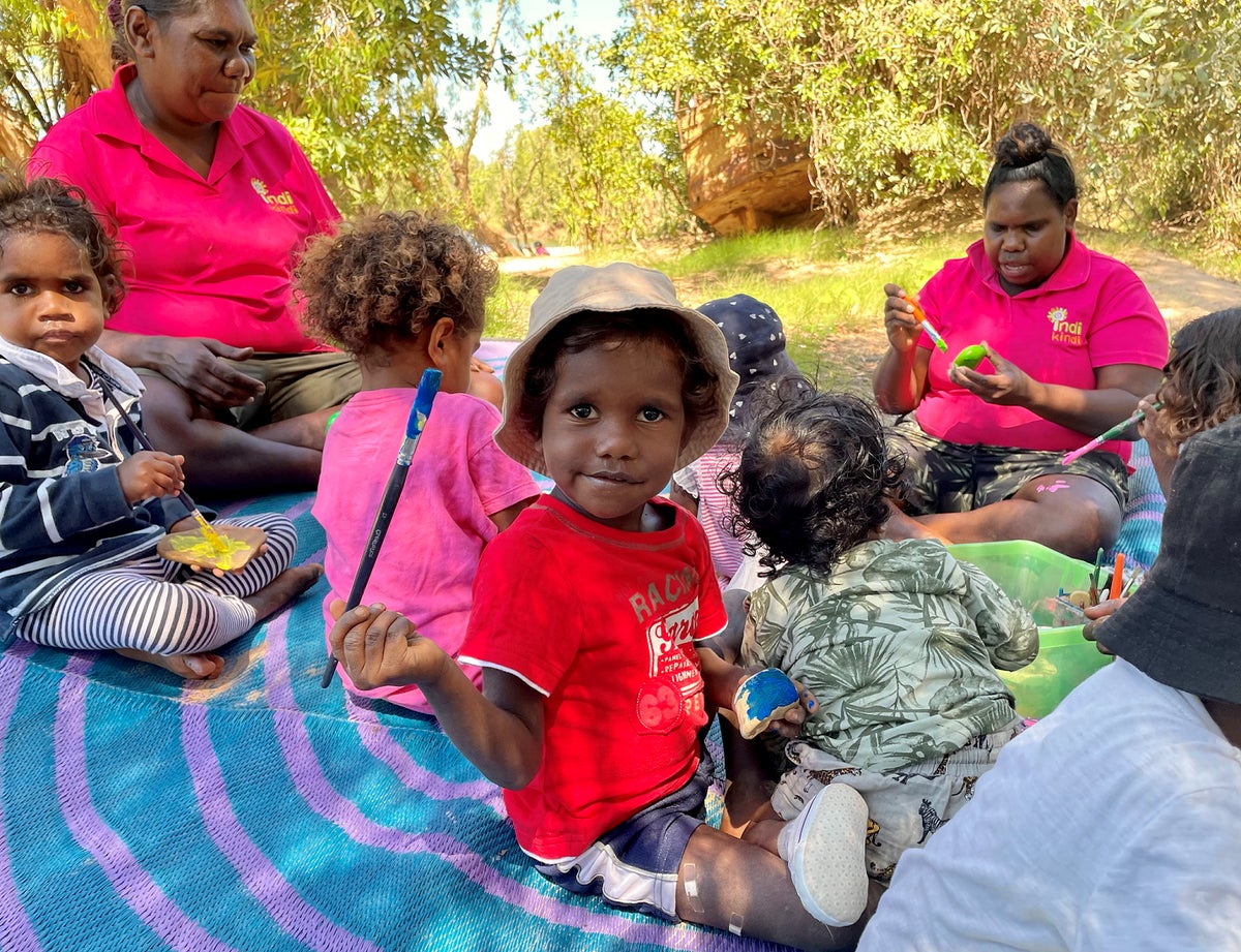 A child at enjoys painting time outside on Country as part of the Indi Kindi program.