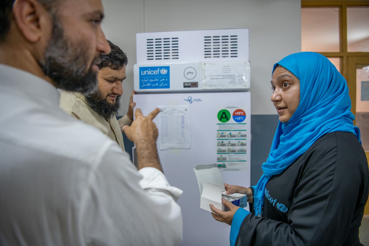 Health workers discussing patients in front of whiteboard