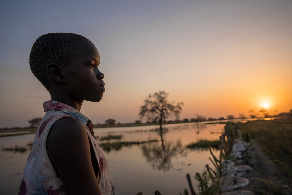 Child surveys the landscape after flooding