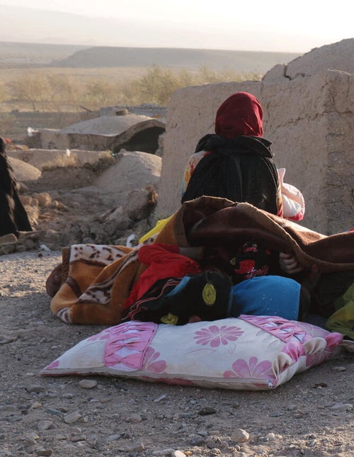 A girl in Afghanistan resting after her home was destroyed from the Earthquake