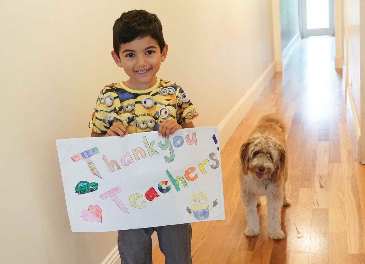 Zac and Max make a thank you sign for teachers.