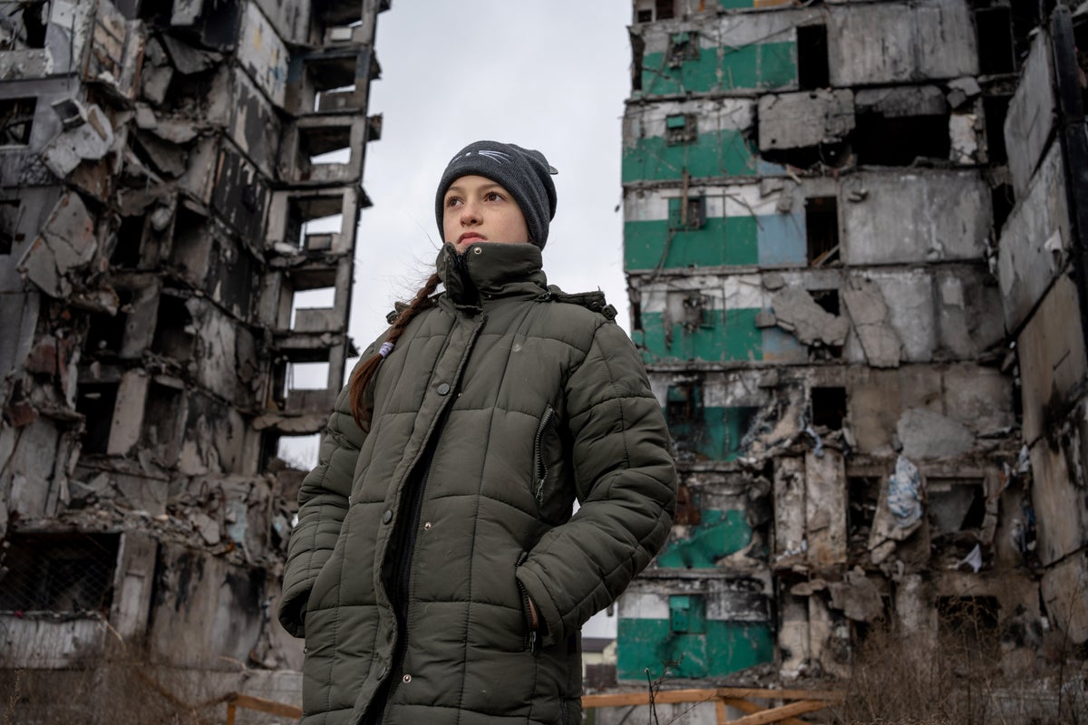 10-year-old Veronica visits the ruins of a high-rise building in Ukraine