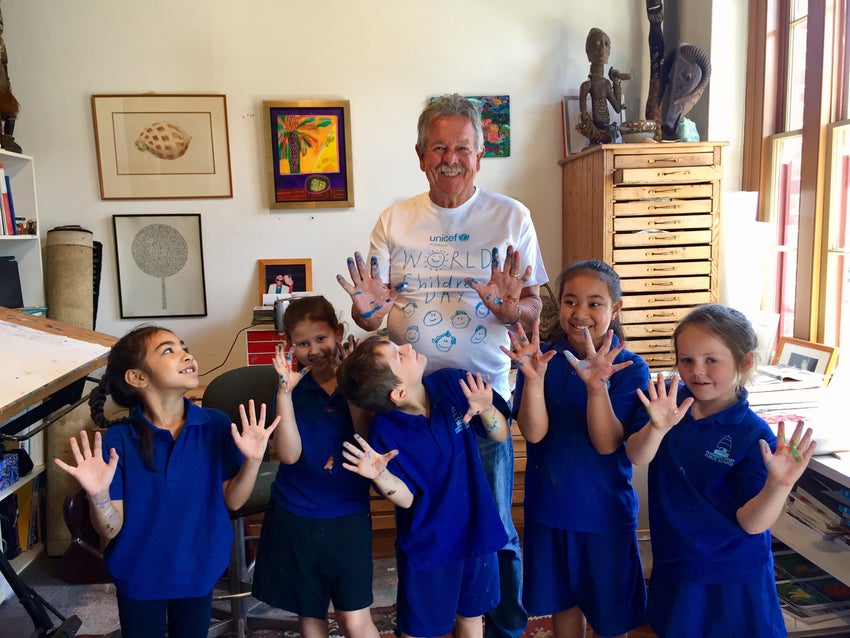 Ken Done smiling with Aussie school kids