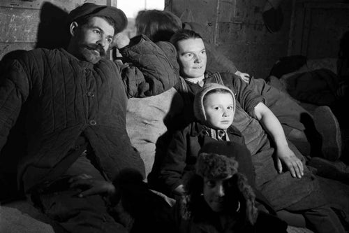 In Poland, 1946, a refugee family returning from Rudki, south of the Ukrainian city of Lvov, rests on a pile of their belongings during their travel west to the farm that awaits them in the south-western Lower Silesia region. © UNICEF Archives 