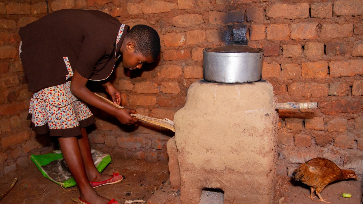 Student uses her newly built rocket stove in her home. 