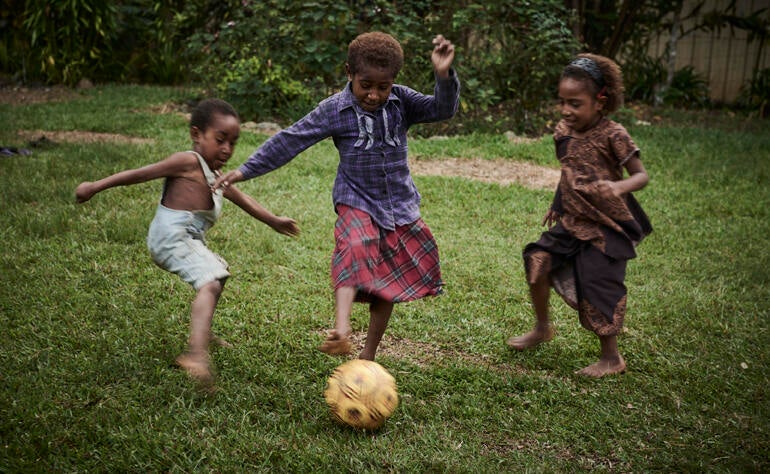 Children in PNG playing soccer