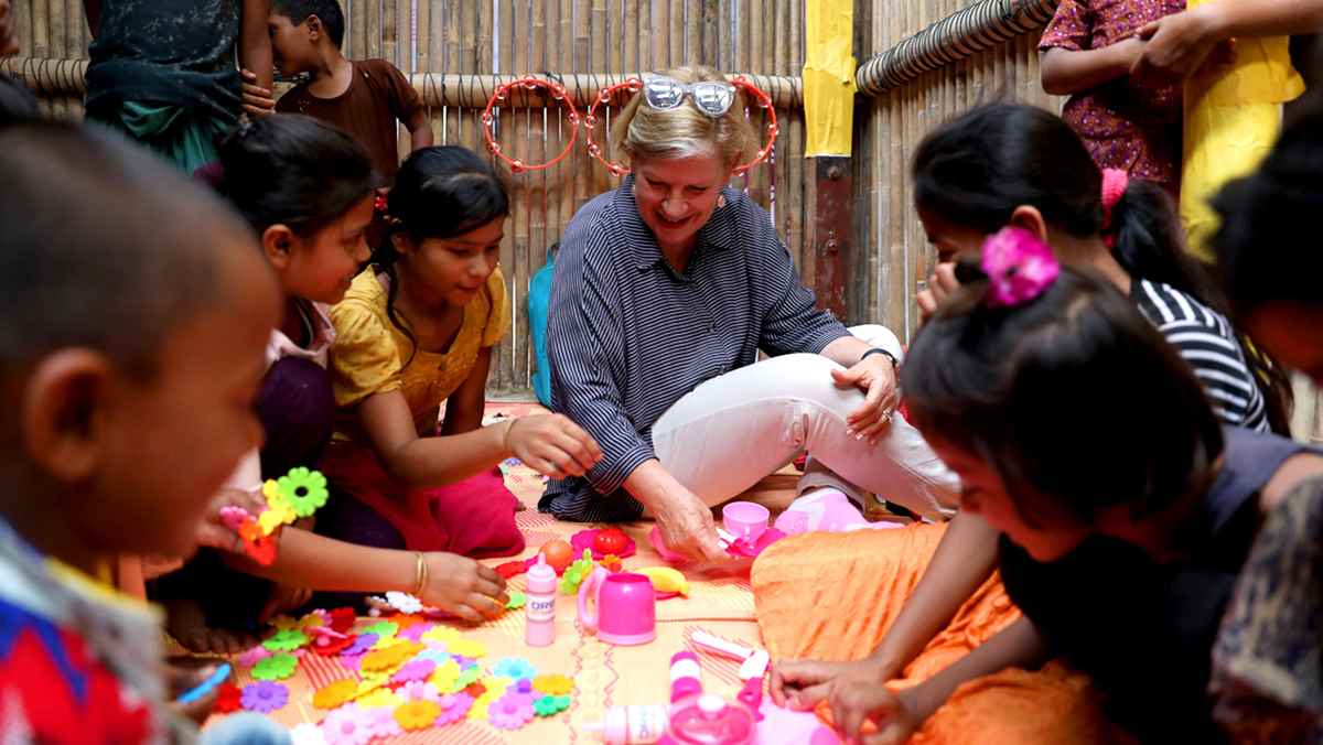 Ann Sherry joins a tea party with some of the children in a UNICEF-supported learning centre