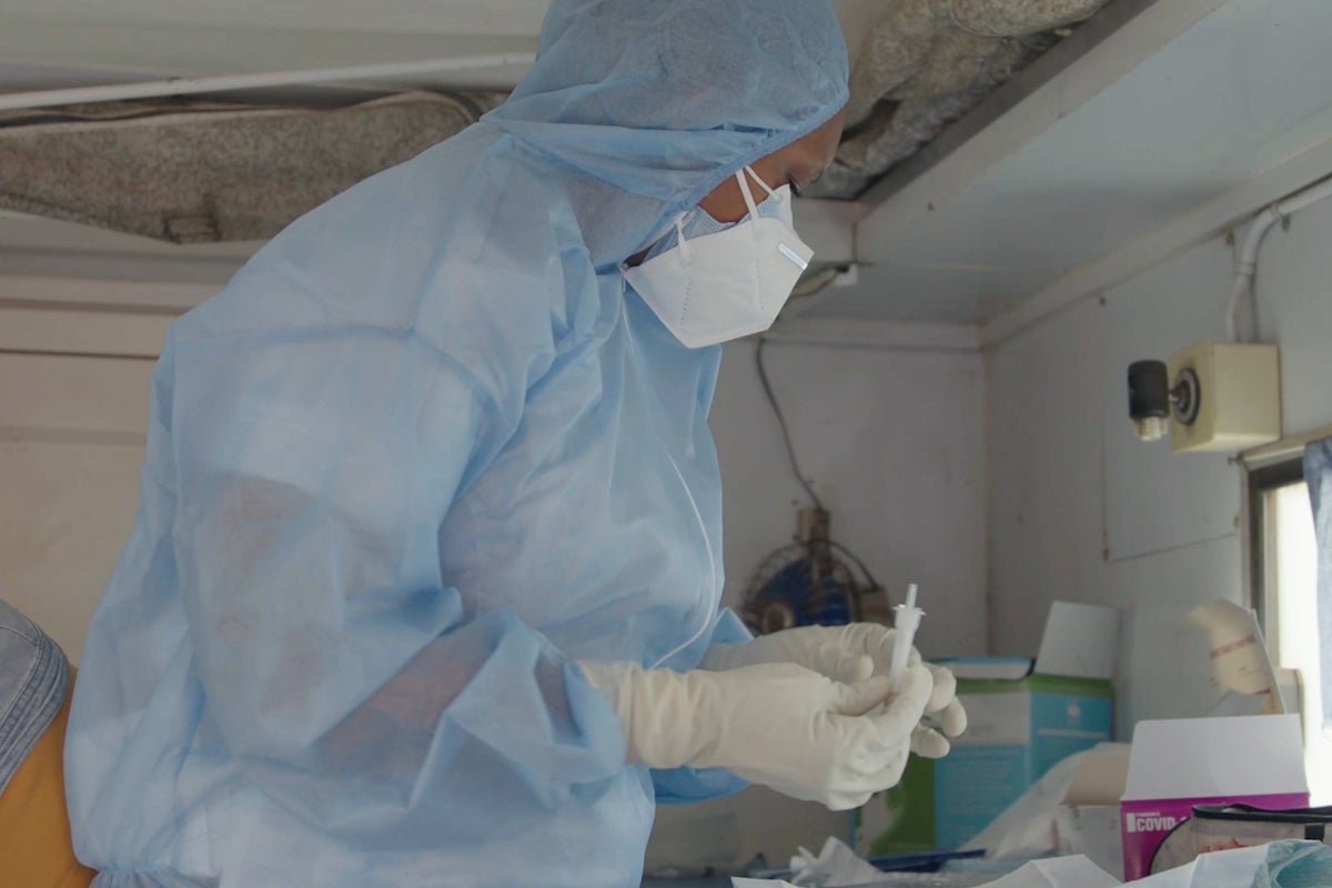 Nurse Zanele prepares a dose of the COVID-19 vaccine.