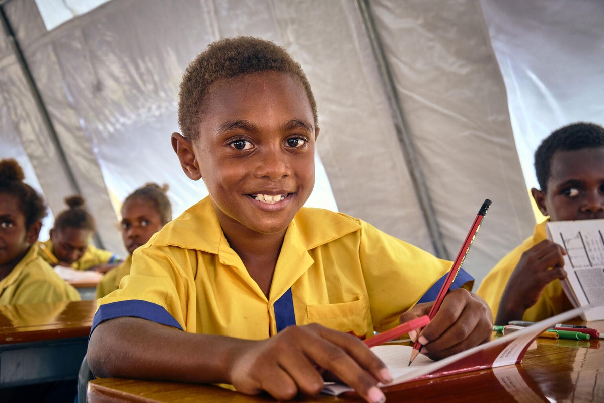 A young boy learning in a UNICEF-supported classroom after the cyclones of 2023.