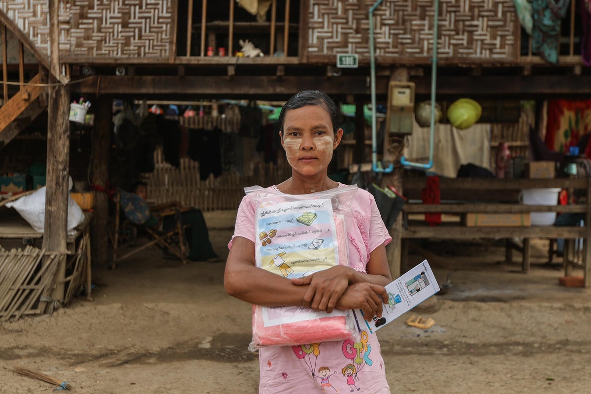 Than Than Sint holds a newborn kit provided by UNICEF, preparing for the arrival of her daughter.
