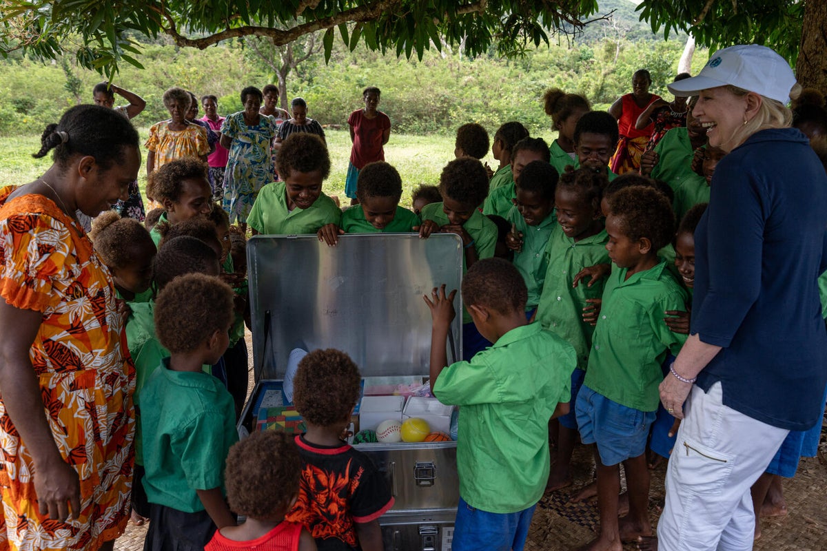 A group of students receive a School-In-A-Box in Vanuatu.