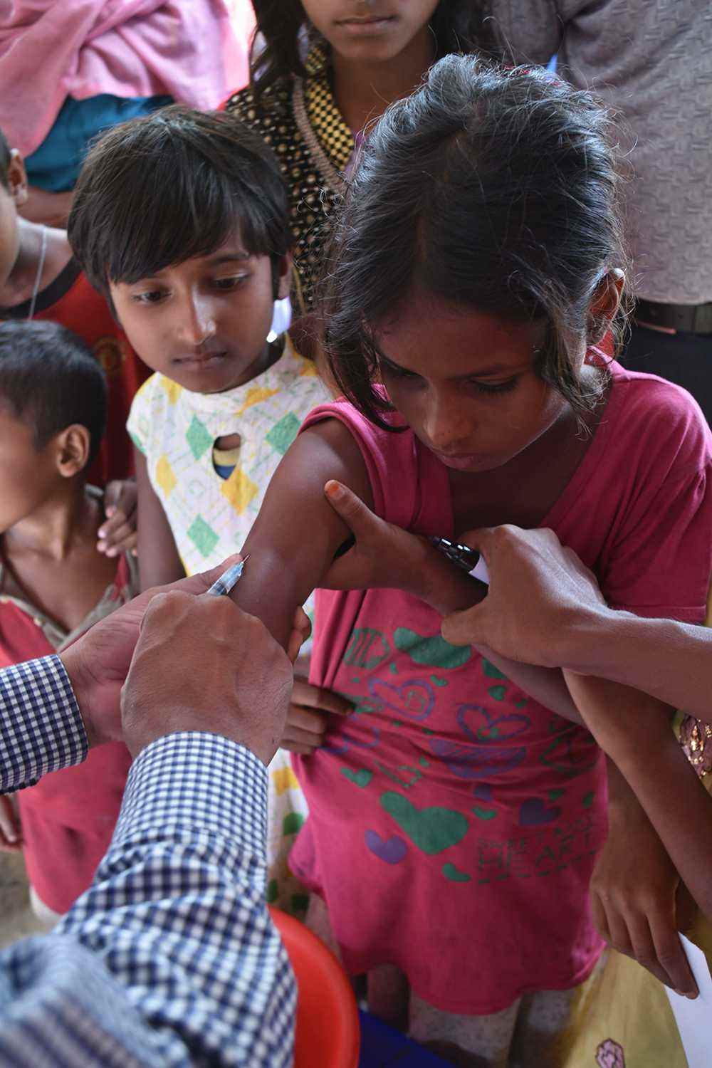 Rohingya children receive an immunisation against measles, which could spread with dangerous speed through crowded refugee camps
