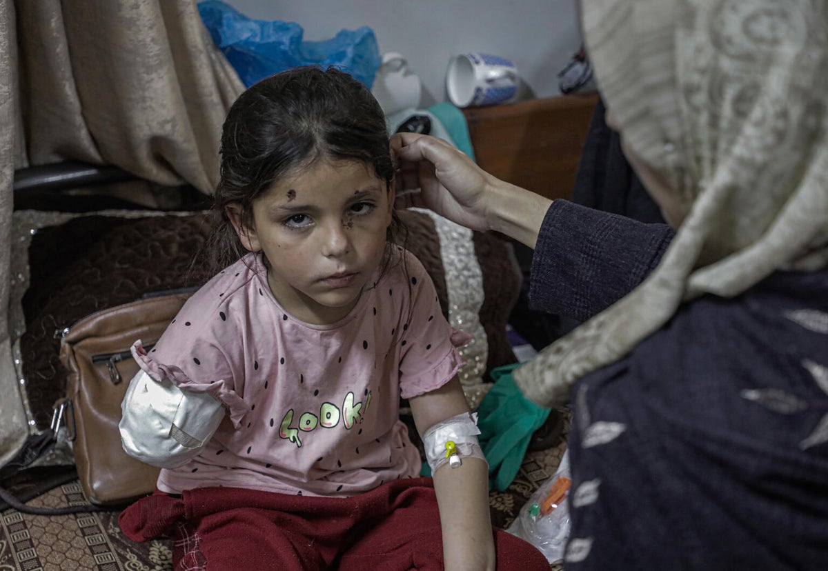 A young girl being treated for injuries from an airstrike on a school in Gaza.