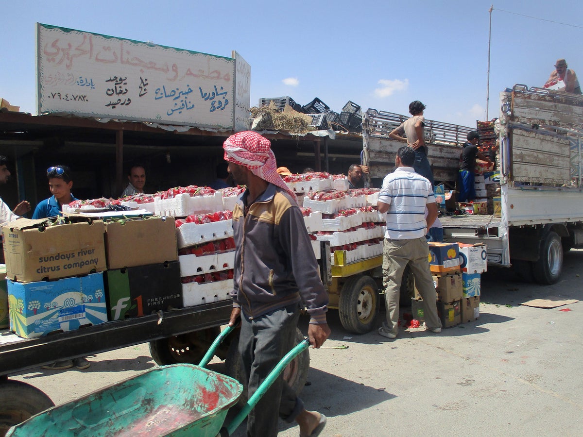 Trucks onloading in what seems a busy market