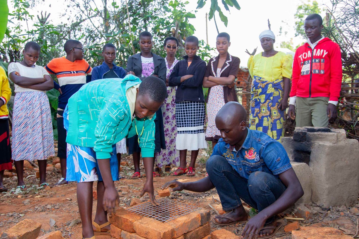 Children building a rocket stove