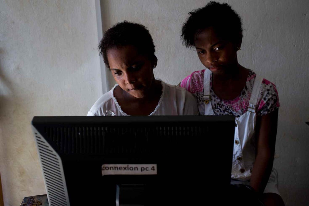 Two females sitting at computer