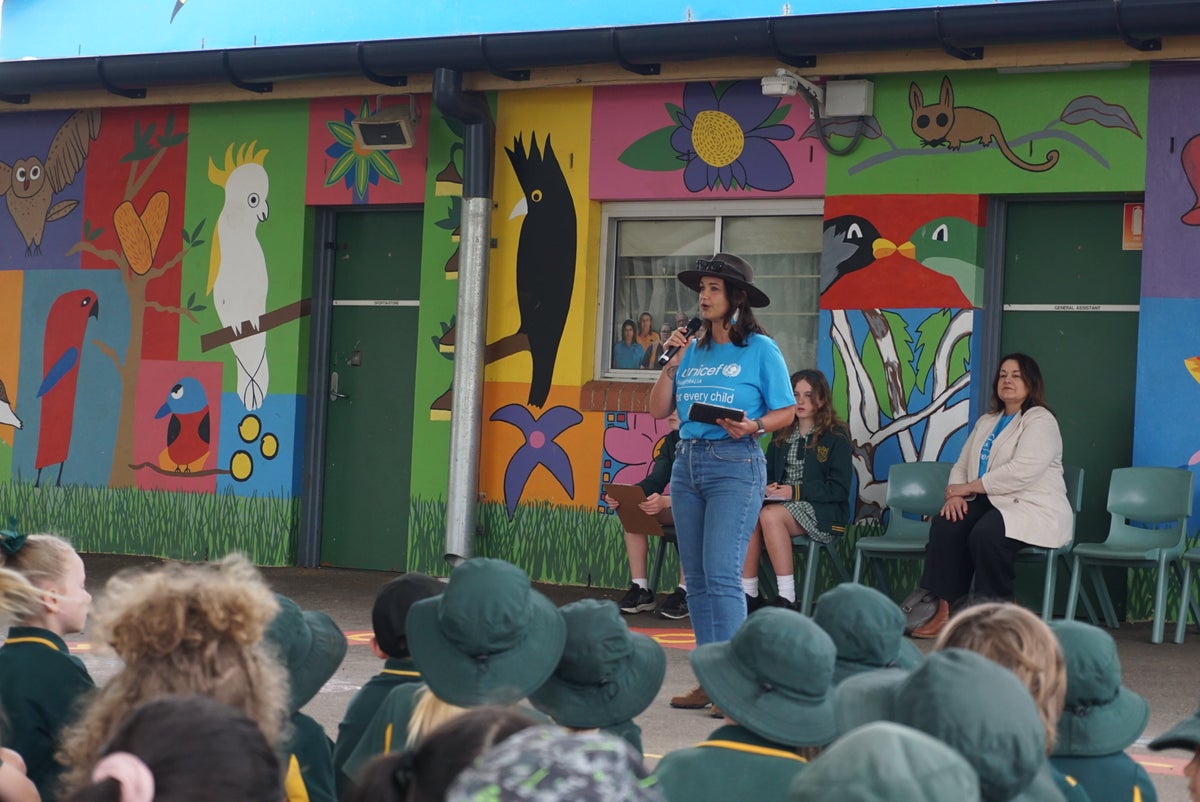 Rae Johnston talks to students during a celebrating for World Children's Day in Australia.
