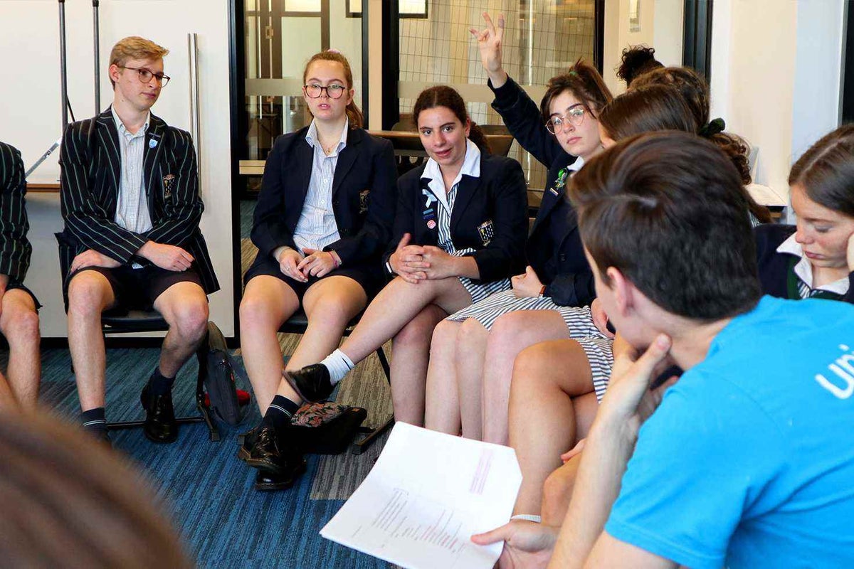 Josh listening to high school children, at a school in Victoria.