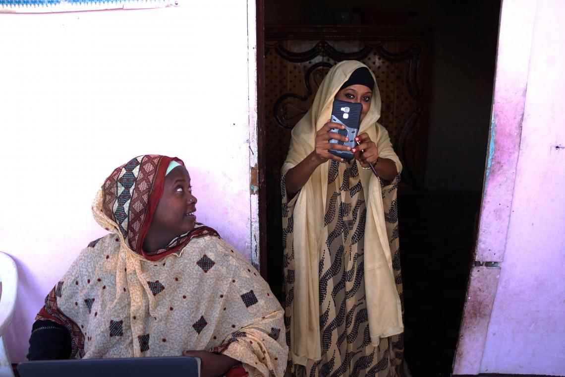 Mariam (left) is now a trained volunteer and works with women like Aicha to change attitudes and behaviours surrounding FGM. 