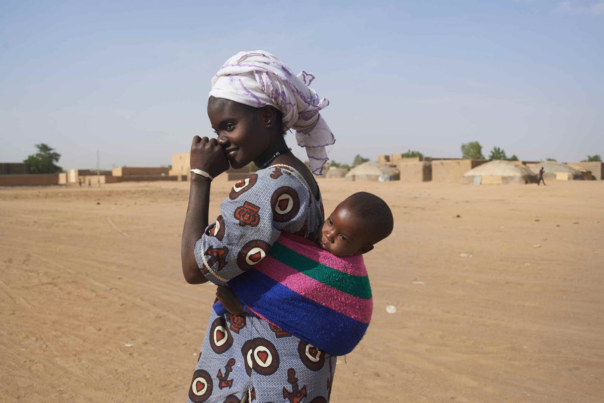 Mariam Mahamame carries her baby son in a sling while walking to a health centre in Gao, Mali, in 2014. 