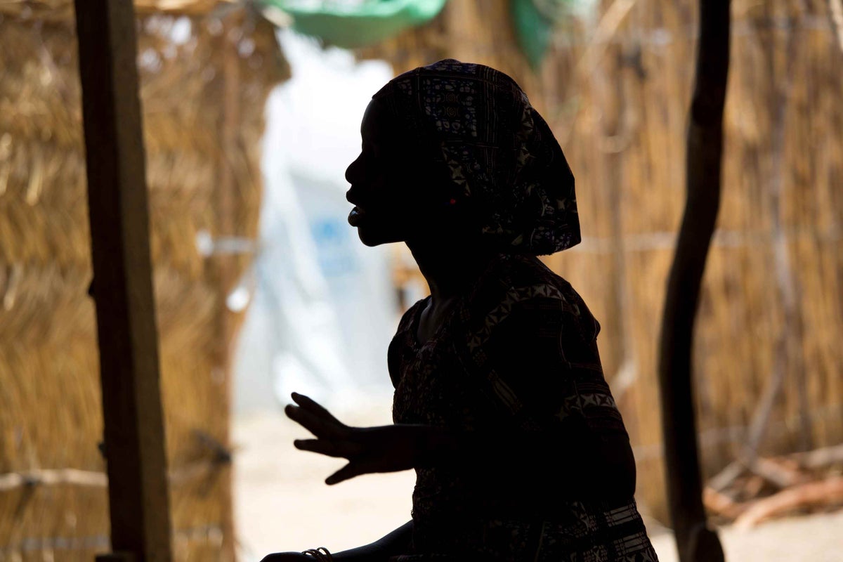 A silhouette of a young woman. You can't see their face.