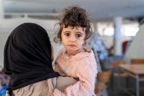 A young child and her family fleeing the conflict in Lebanon.