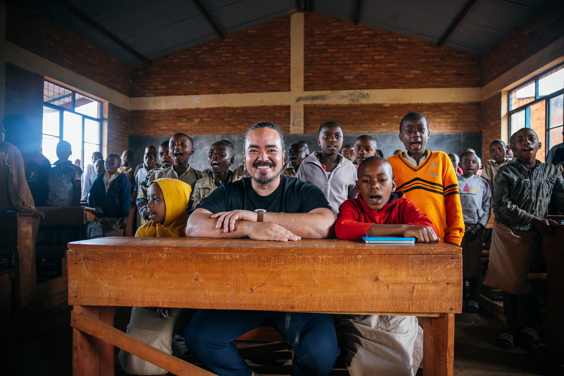 Adam Liaw with students in a classroom in Burundi