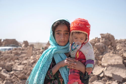 Afghan children beside damaged houses after earthquakes devastated communities in October 2023. 
