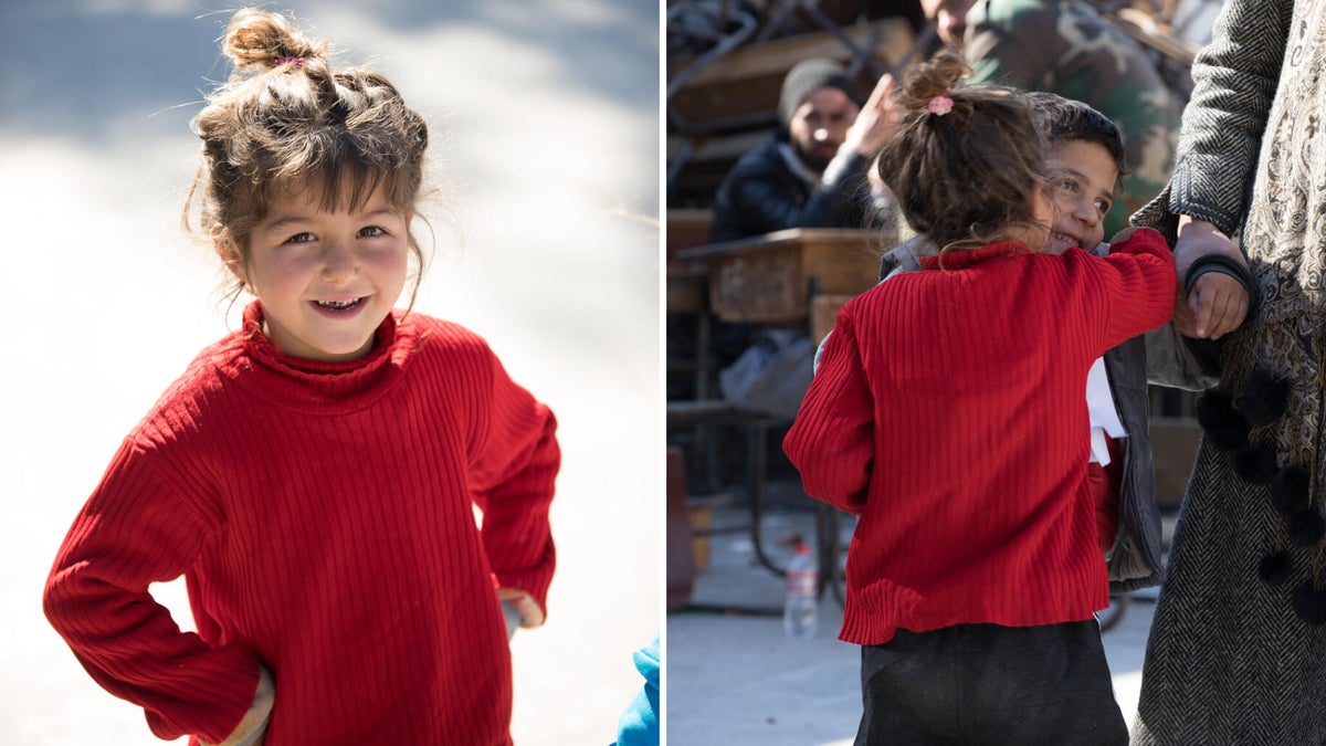 A young girl hugging her friend. 