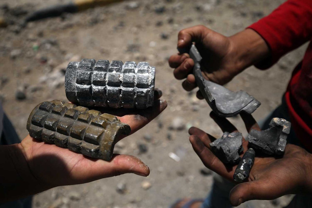 Kids hold shrapnel they have found 