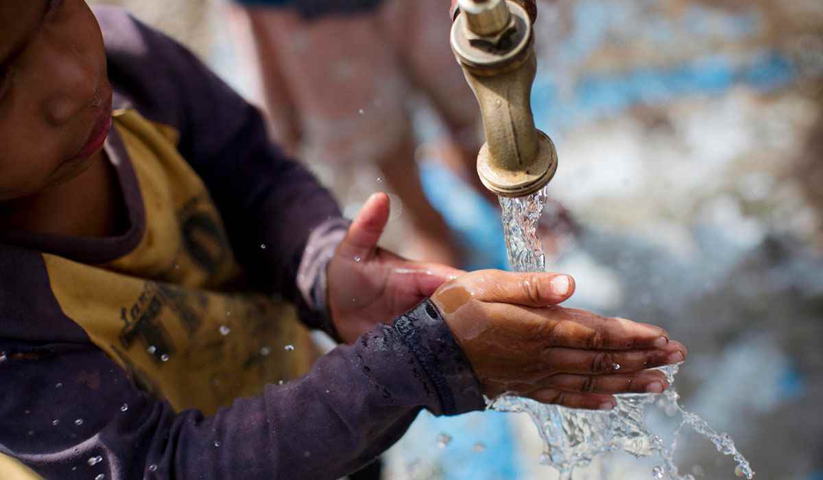 A young child washes his hands from a water tap that was installed by UNICEF at a school in the Southern Highlands Province, Papua New Guinea. 
