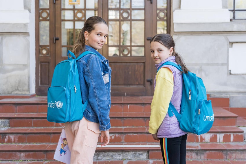 Two girls wearing UNICEF backpacks