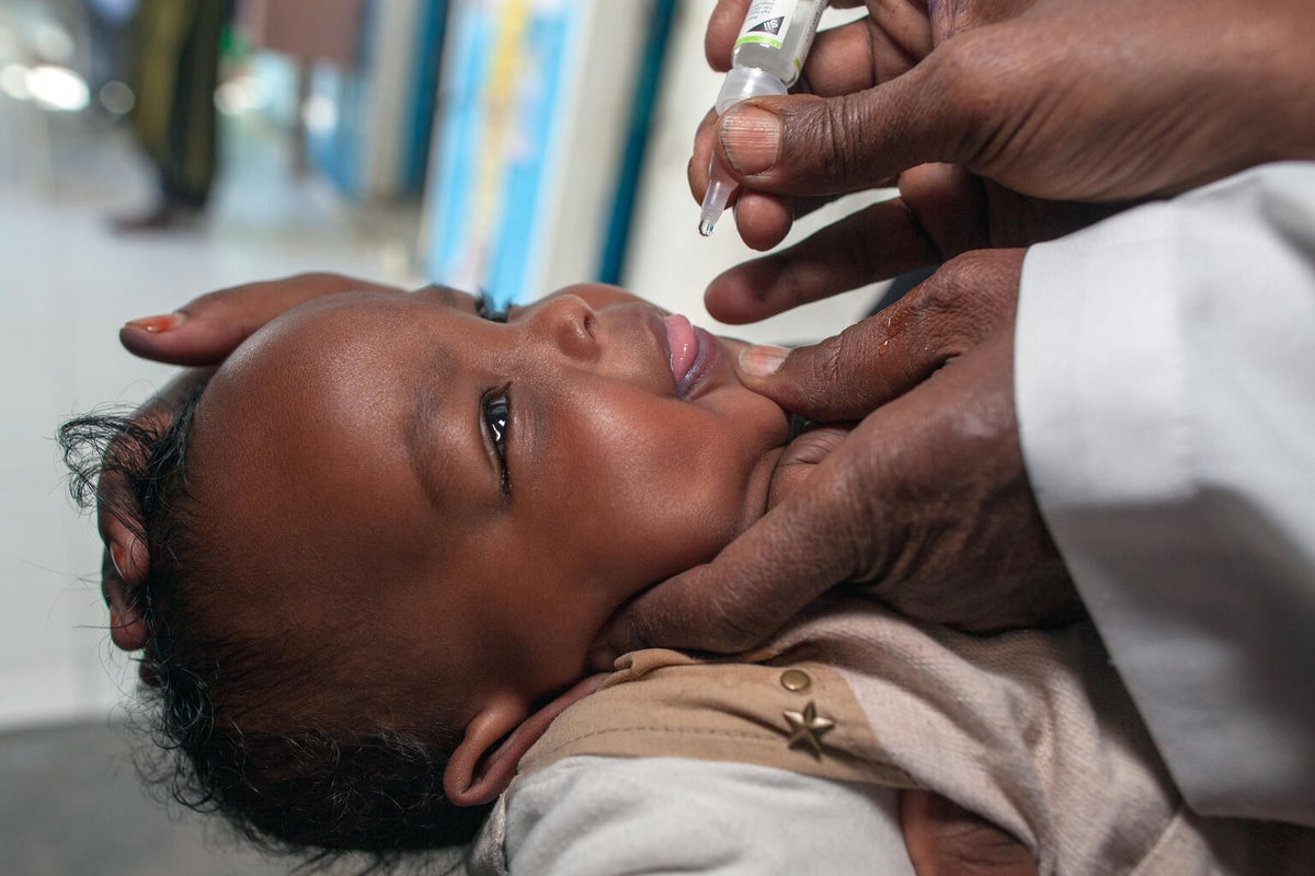 In Somalia, a child receives an oral polio vaccine at a UNICEF-supported Nutrition Health Centre.