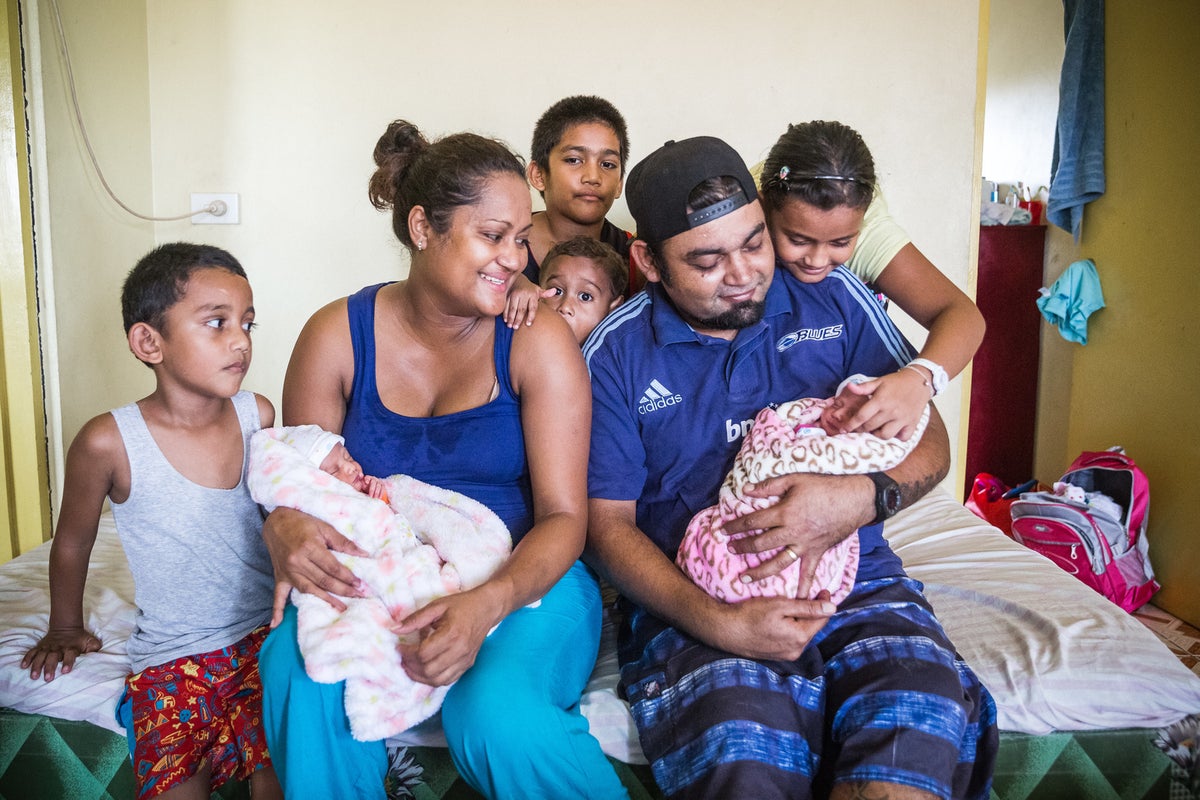 A family photo. Mum, dad, the two newborn twins and four children around them.