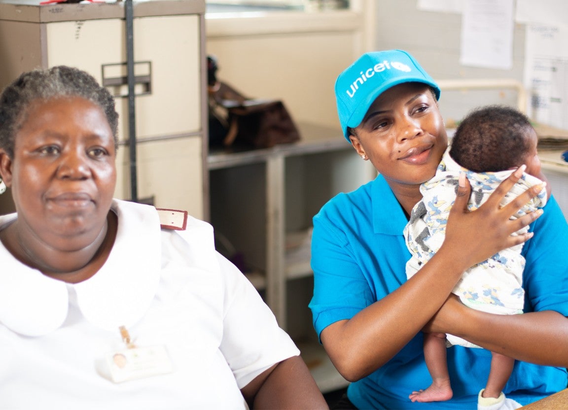 Health workers and UNICEF staff look after a newborn baby at a UNICEF-supported clinic in rural Zimbabwe. 