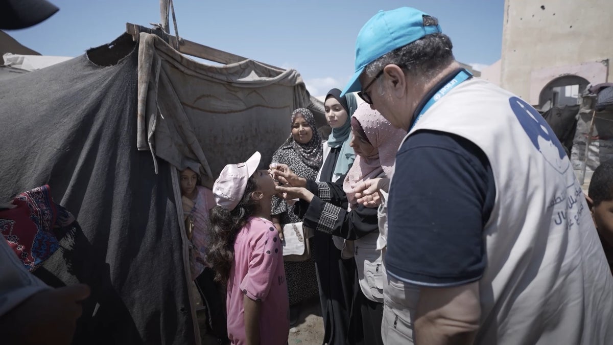 Dr. Awadallah joins an outreach team to vaccinate displaced children against polio in Gaza.