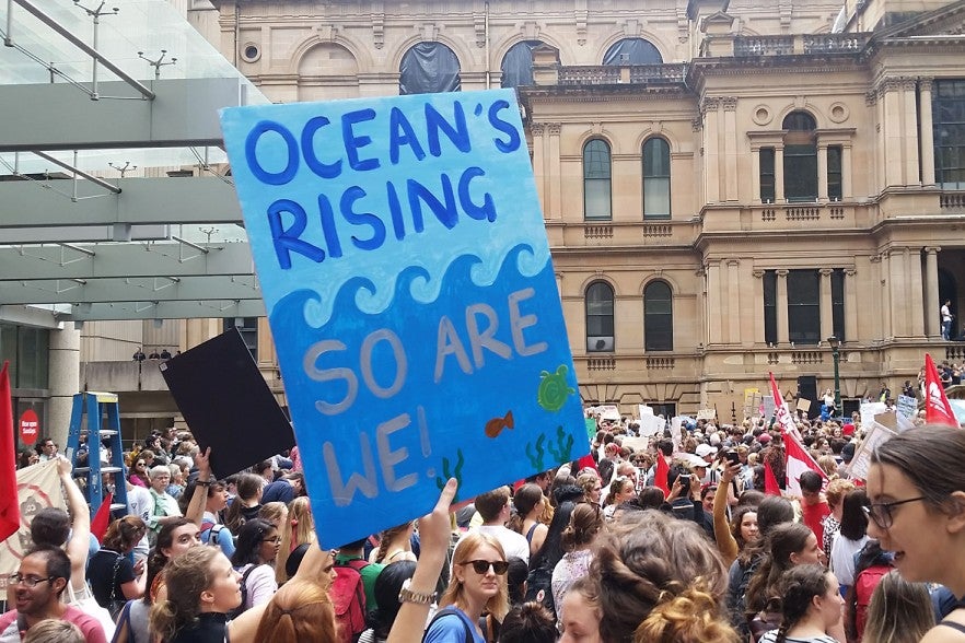 "Ocean's rising, so are we" was carried through the crowds in Friday's rally. 