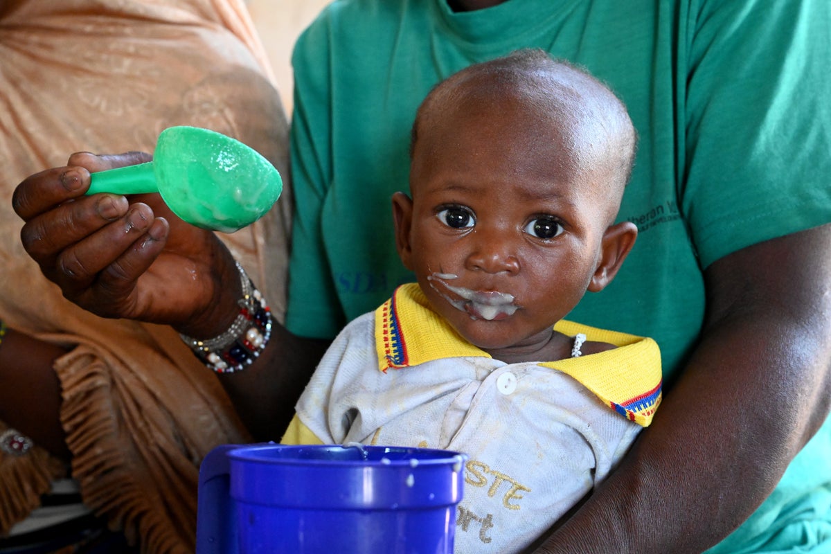 Children receive a nutritious meal at a health centre in Burkina Faso