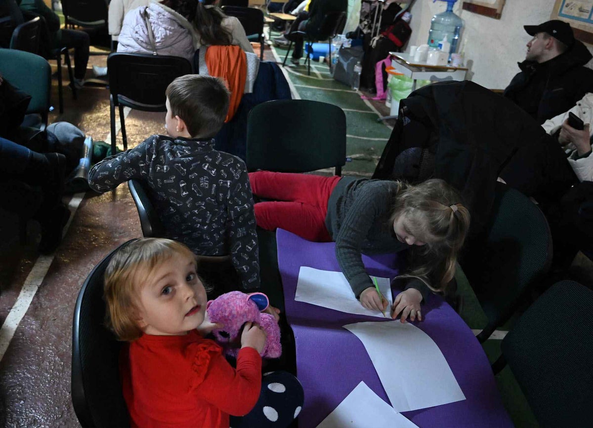 In Kyiv, children play and draw in an air raid shelter. 