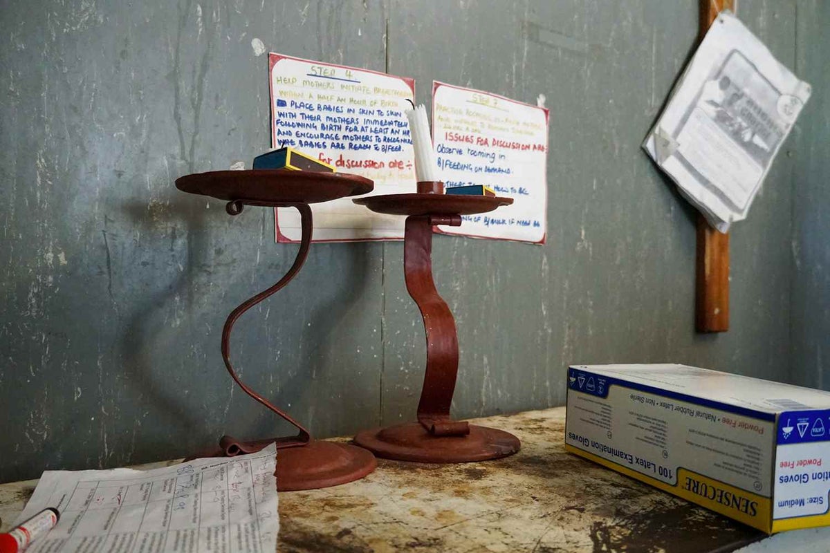 Two candles in the labour ward of a district hospital. When power goes out at night, these candles are the only source of light available to staff as a woman gives birth. 