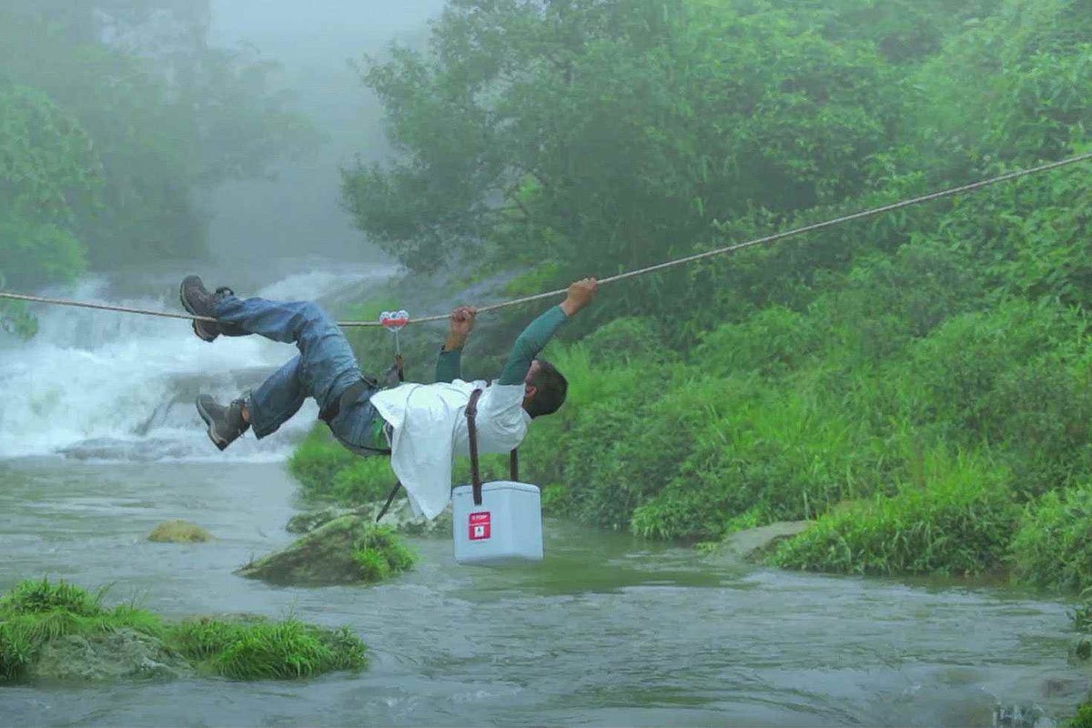 A vaccine carrier is carefully transported across a river in India. It’s a delicate process - the vaccines need to be kept cold, even in tropical parts of the world