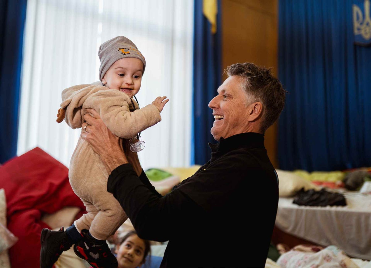 UNICEF Spokesperson James Elder plays with 15-month-old Artur at an air-raid shelter in Lviv, western Ukraine. Fleeing for the second time, Artur's family hope to cross the border.