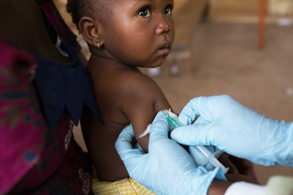 child receiving needle immunisations