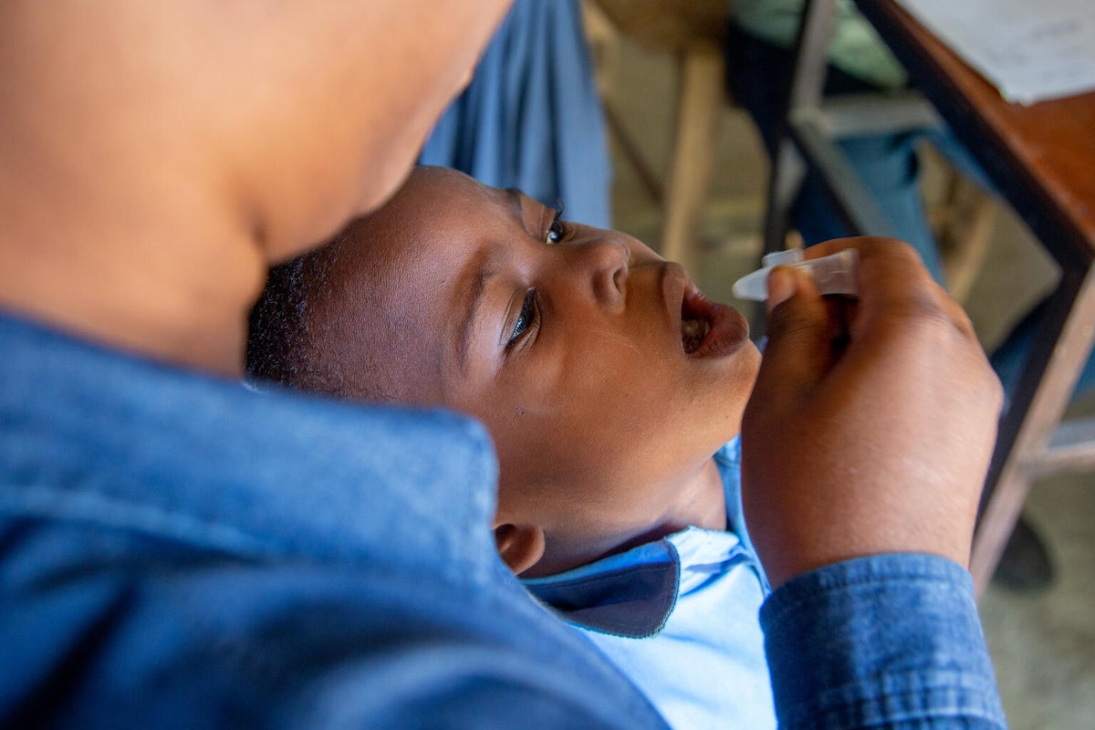 A young boy is getting vaccinated for cholera