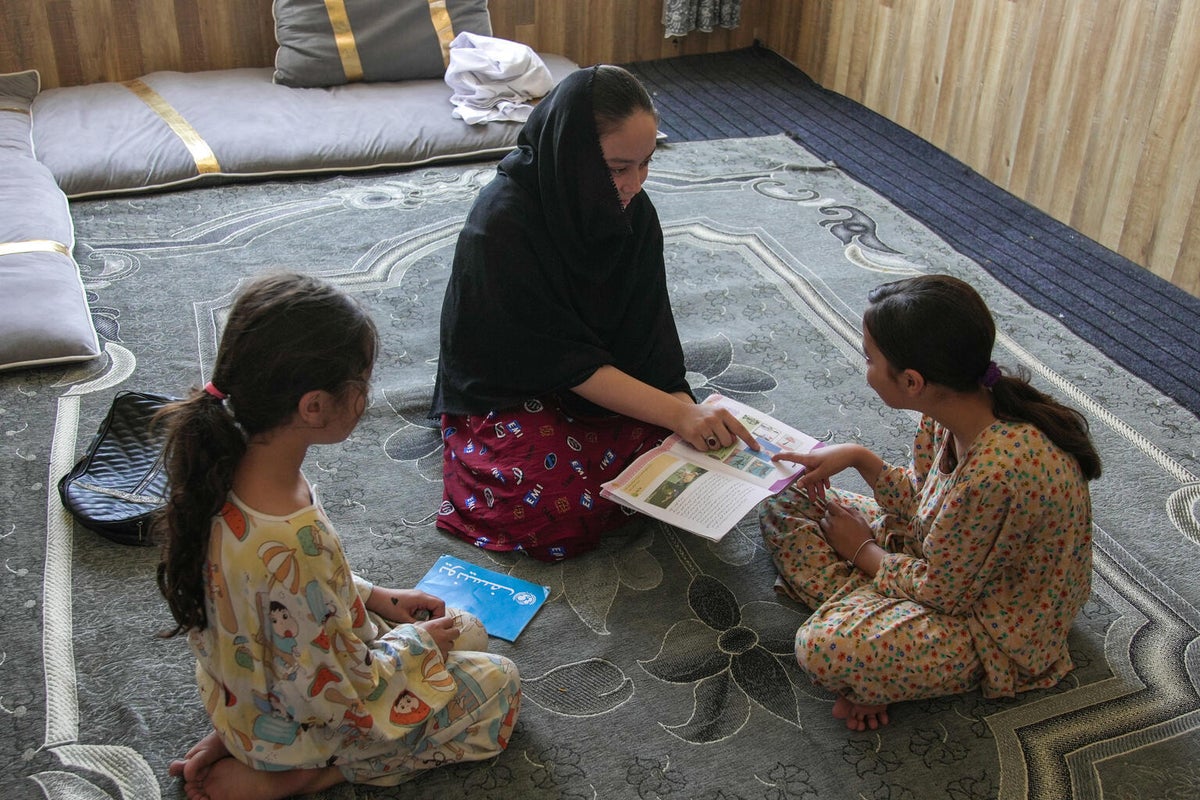 Kawar helps her younger sisters with their homework.