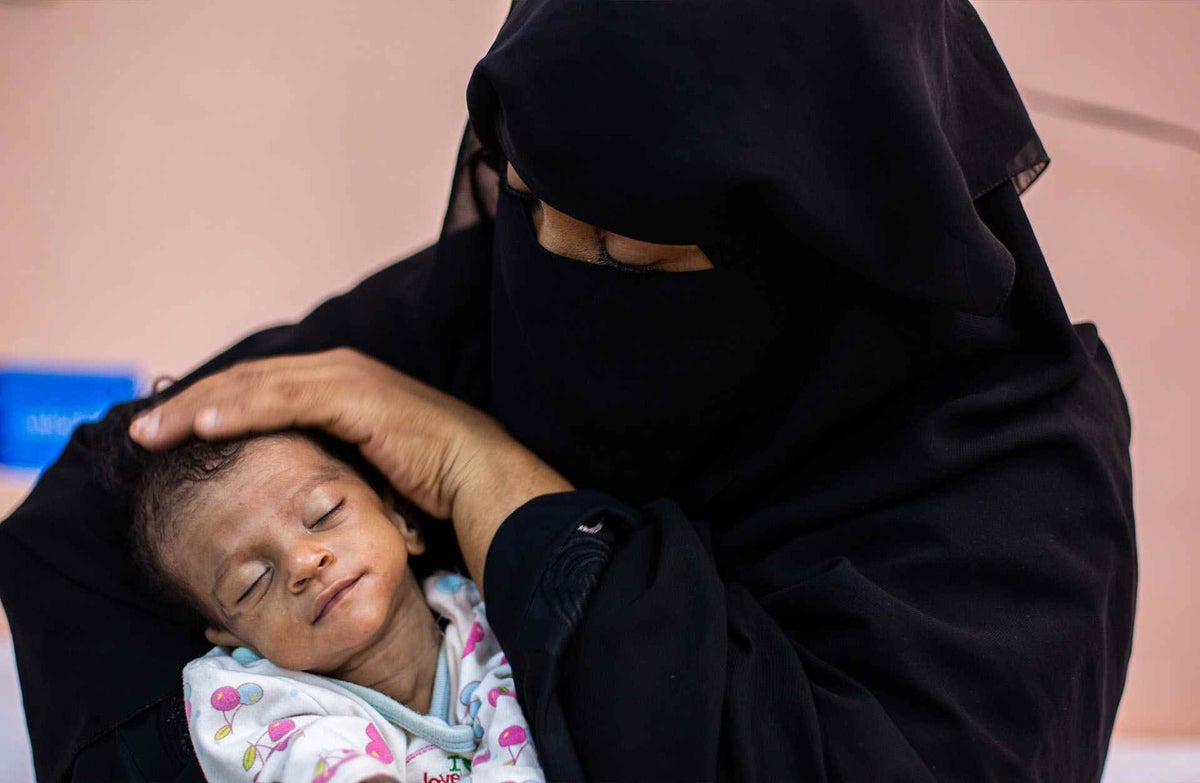 Mother in niqab with child