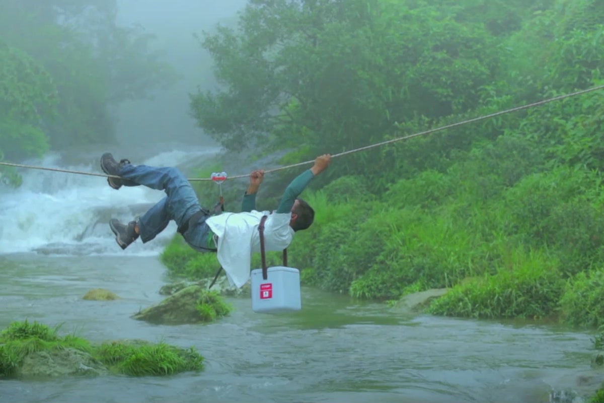 A vaccine carrier is carefully transported across a river in India. It’s a delicate process - the vaccines need to be kept cold, even in tropical parts of the world. 