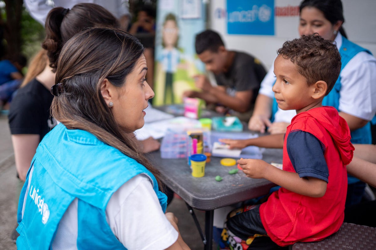 A young boy speaks with a UNICEF specialist in Guatamela.