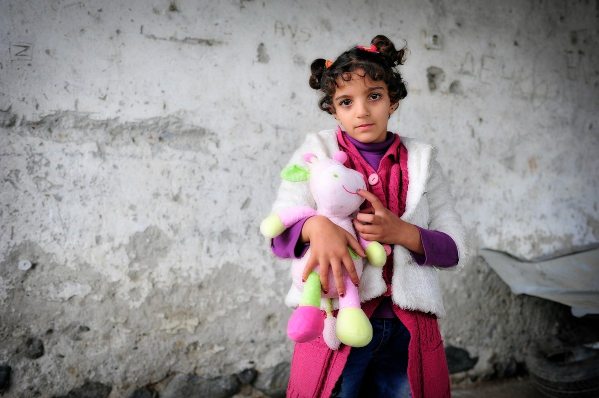 Young girls holds her teddy bear